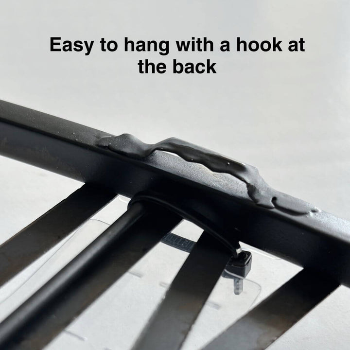 Back view showing easy-to-hang hook on black metal wall clock