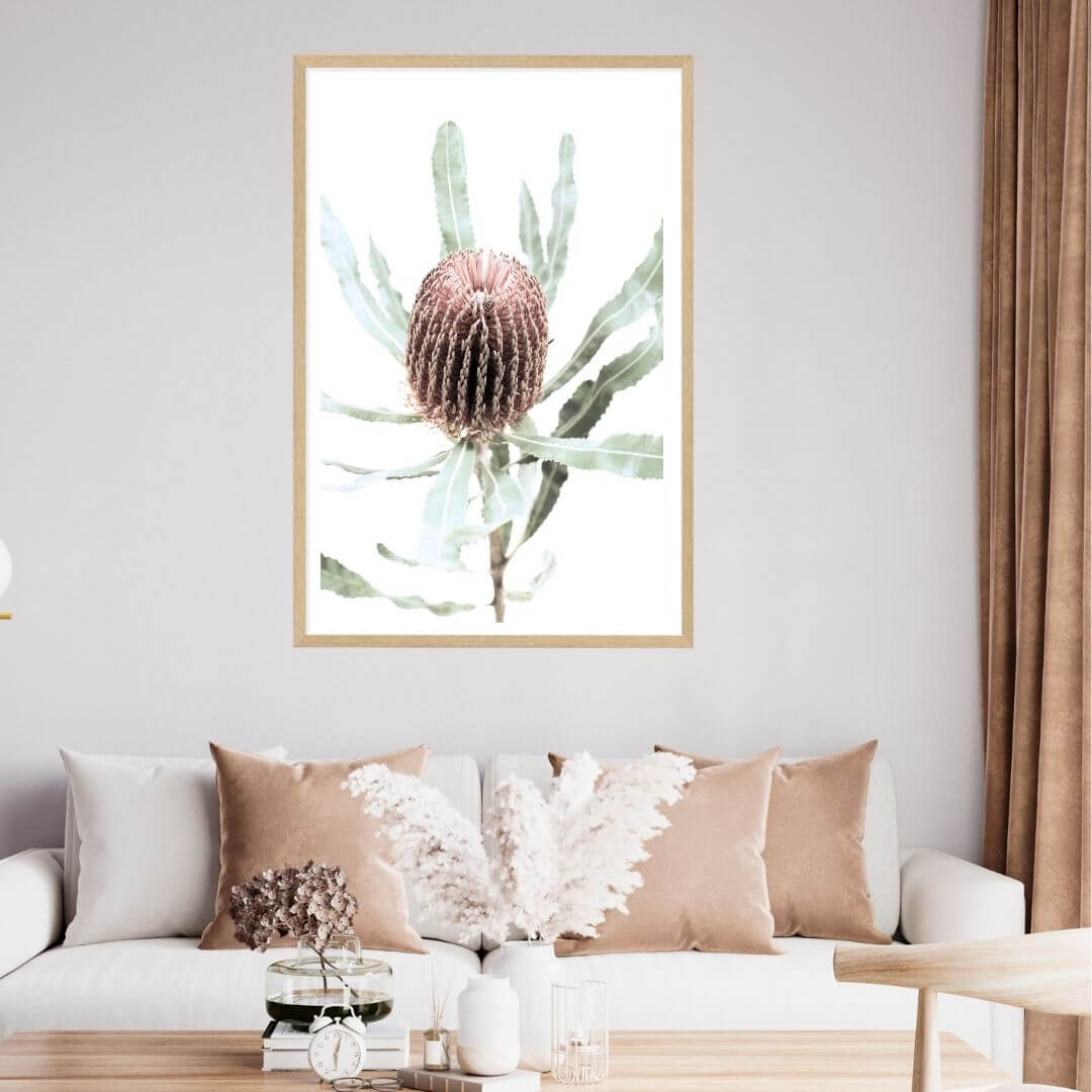 A floral Australian Natives artwork of one Australian native peach Banksia flower B in a timber framed print on a living room wall.