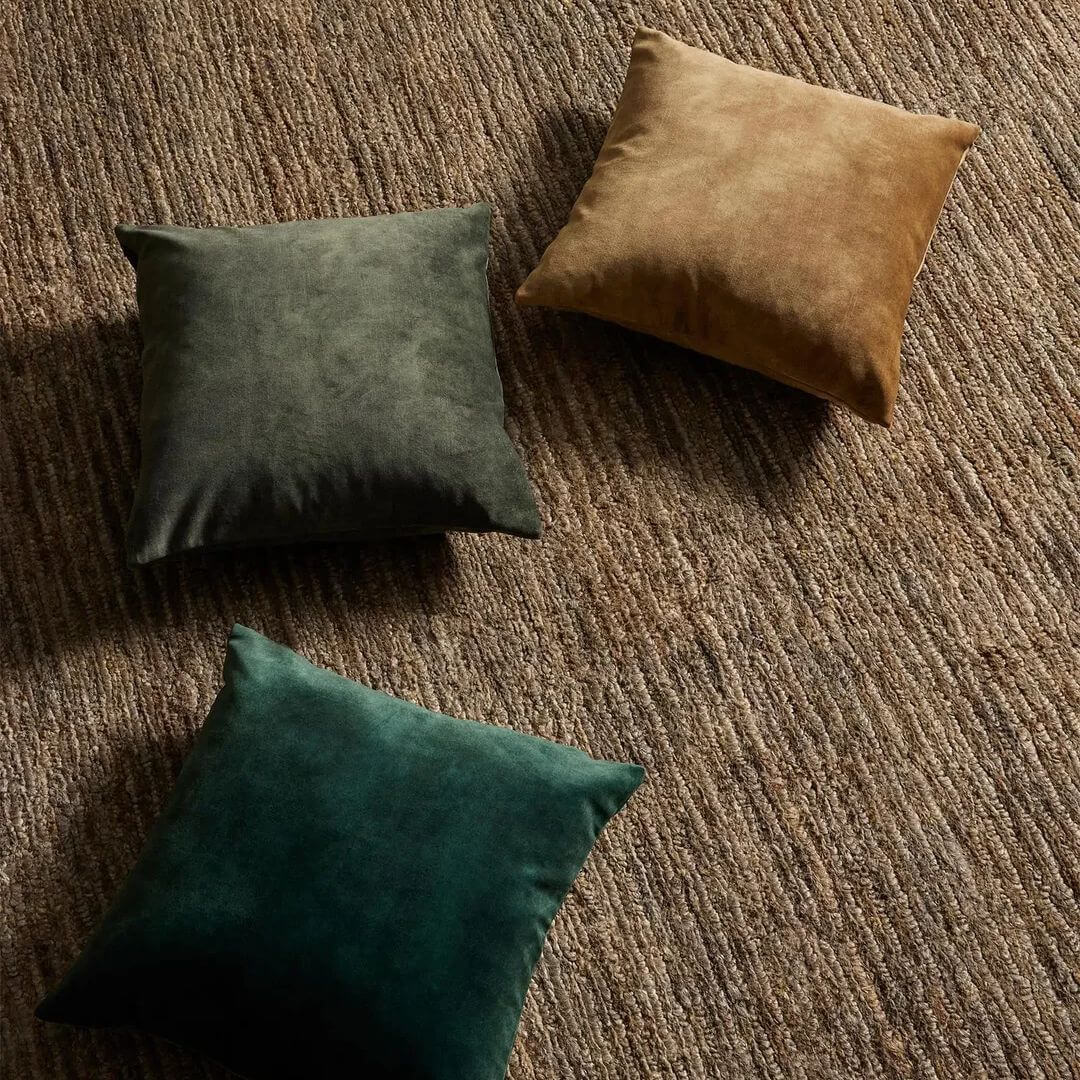 3 Ava Square Velvet Cushion in 50cm on a dark brown rug
