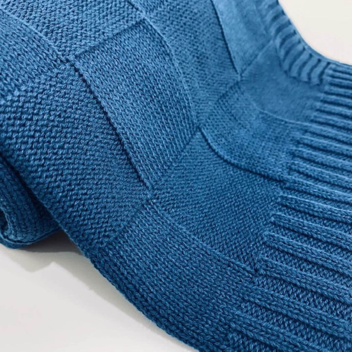 A super soft, light weight Knitted Baby Blanket by Anchor and Arrow perfect to wrap your baby and keep them comfy.