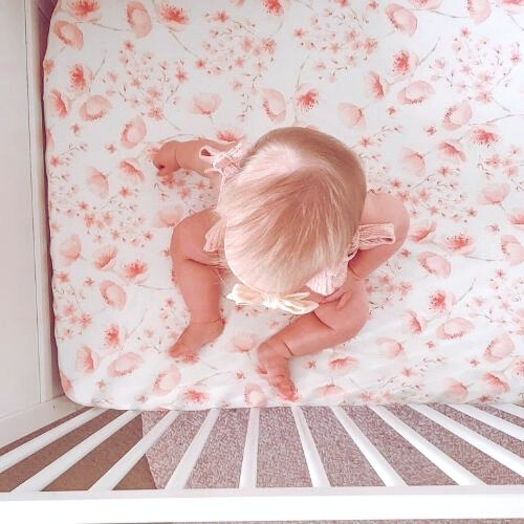 A breathable Jersey Cotton Fitted Baby Cot Sheet in a cute Cherry Blossom pattern.
