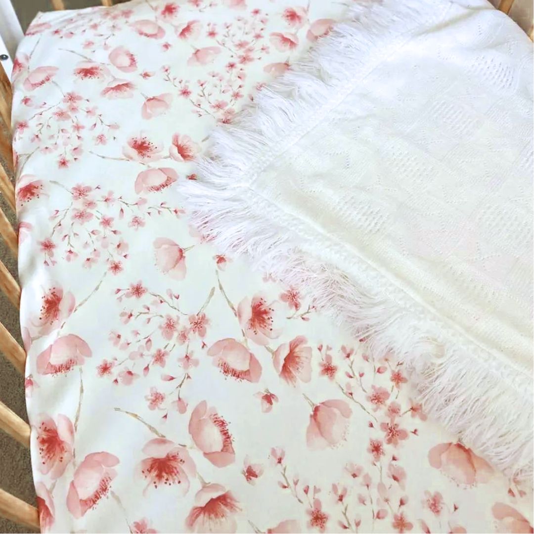 A comfy Jersey Cotton Fitted Baby Cot Sheet in a pretty pink Cherry Blossom design.
