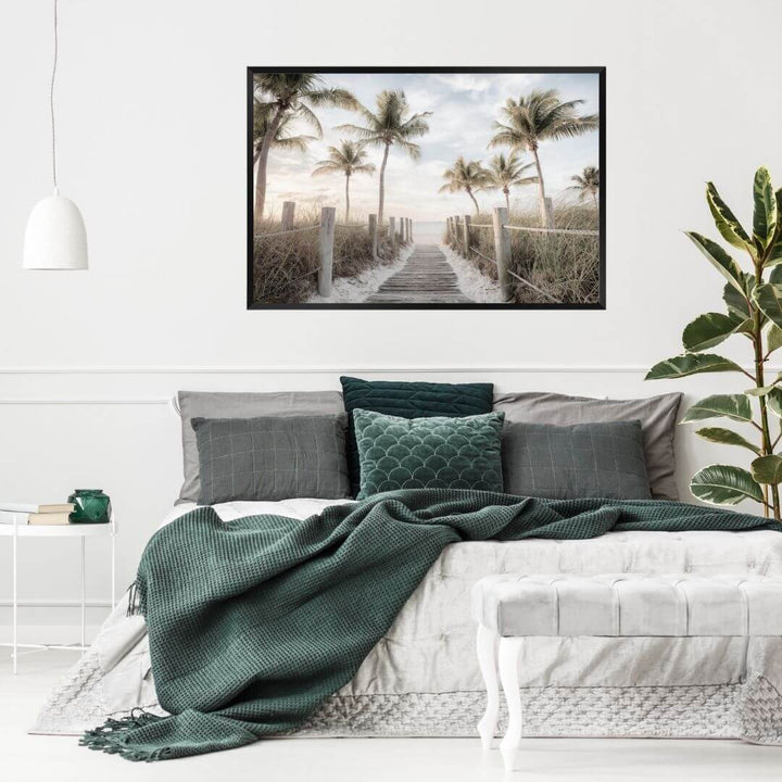 A coastal wall art photo print of a pathway to a beach on the keys Florida with palm trees with a black frame, no border on bedoom wall