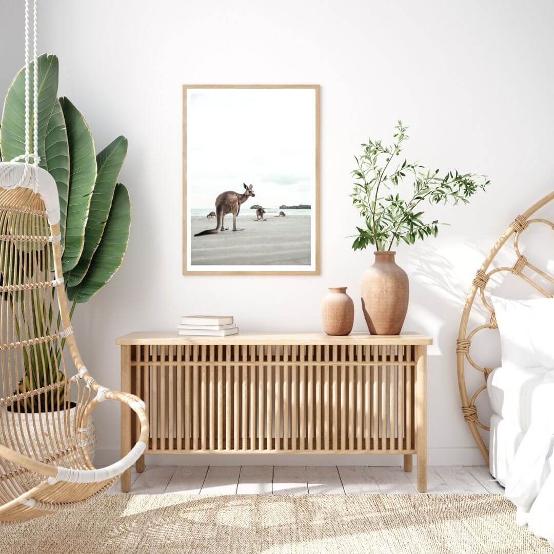 A wall art photo print of beach side kangaroos with a timber frame to style a coastal Australian bedroom