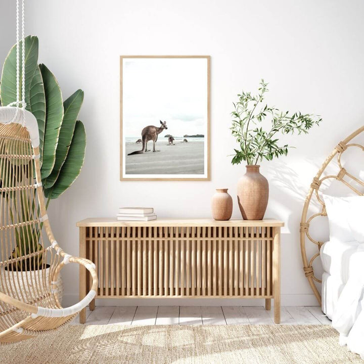 A wall art photo print of beach side kangaroos with a timber frame to style a coastal Australian bedroom