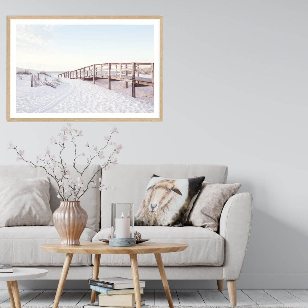 A wall art photo print of a beachside boardwalk with a timber frame or unframed for your coastal living room behind sofa