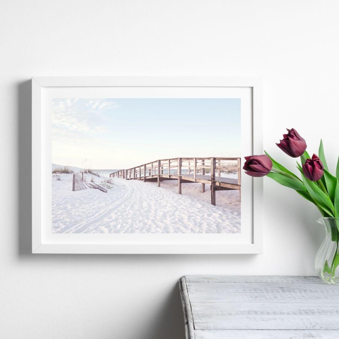 A coastal wall art photo print of a beachside boardwalk with a white frame or unframed to style shelves and empty walls