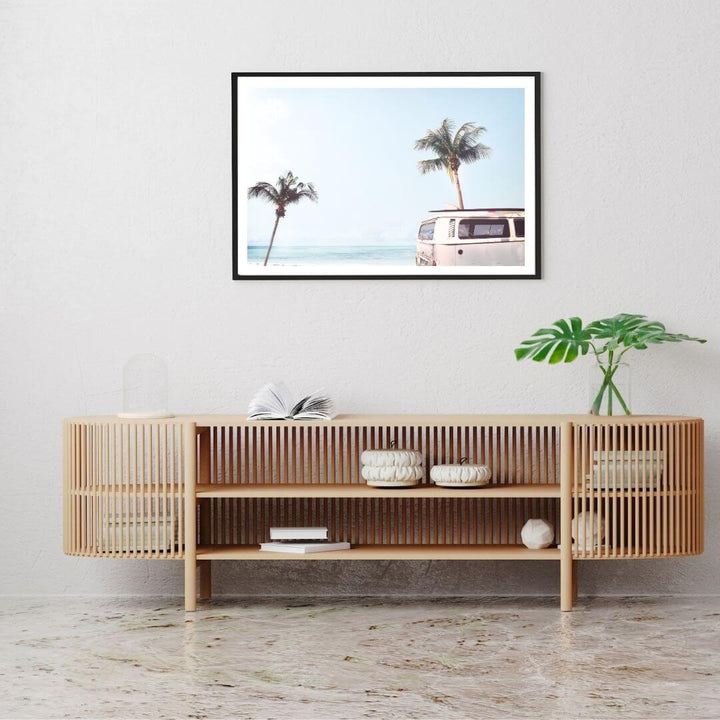 A coastal wall art photo print of a beige beachside kombi van with a timber frame to decorate your console table