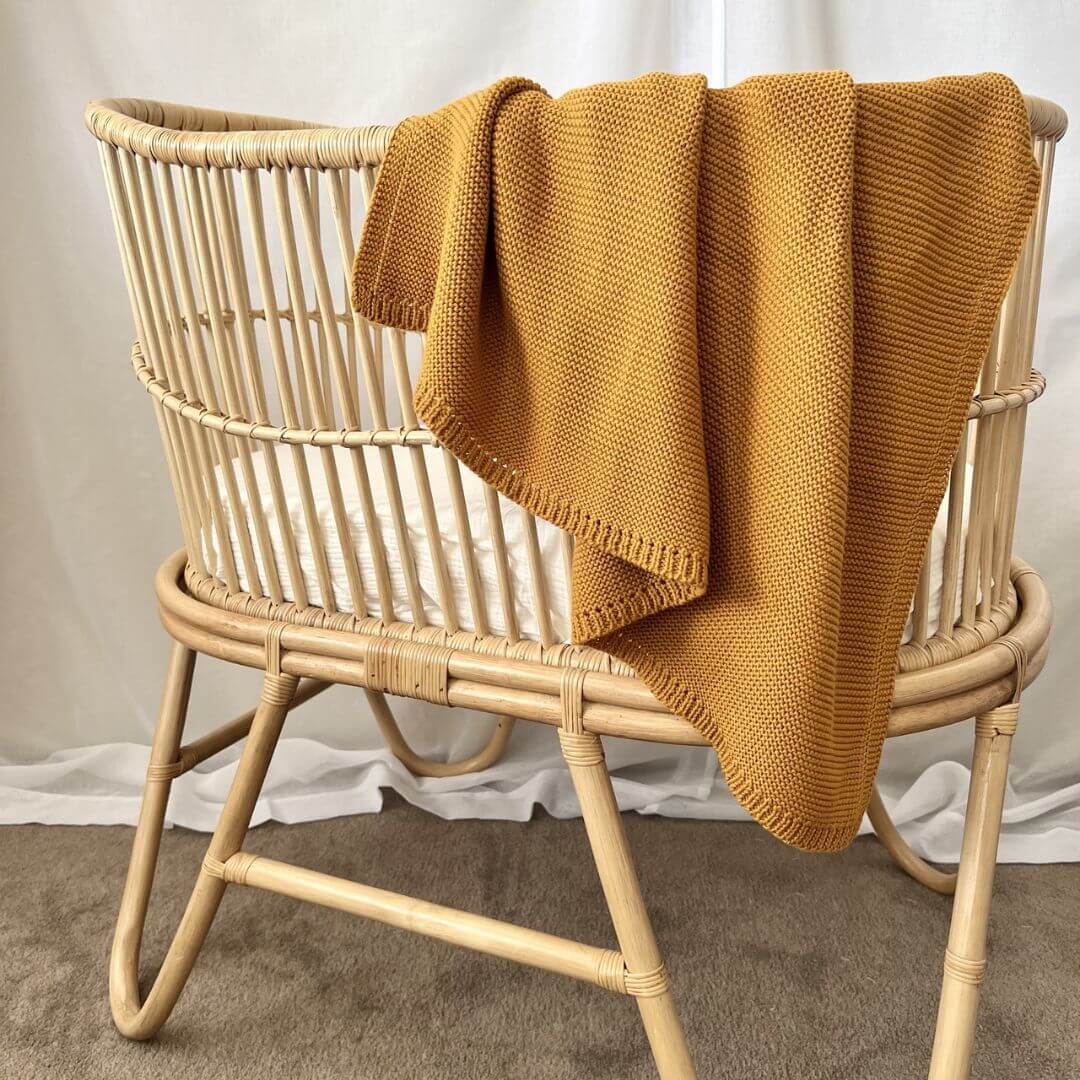 A lusciously soft Cable Knitted Baby Blanket in beautiful Mustard Yellow to wrap your baby. 