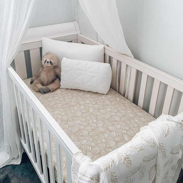 A lightweight pink Jersey Cotton Fitted Baby Cot Sheet in a coastal Sandy Shell design.