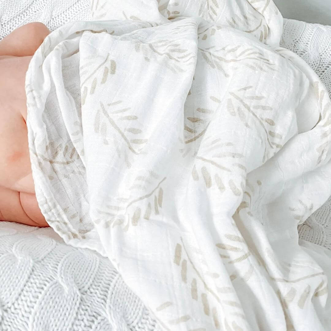 Close-up of soft organic bamboo cotton baby swaddle texture and fern pattern