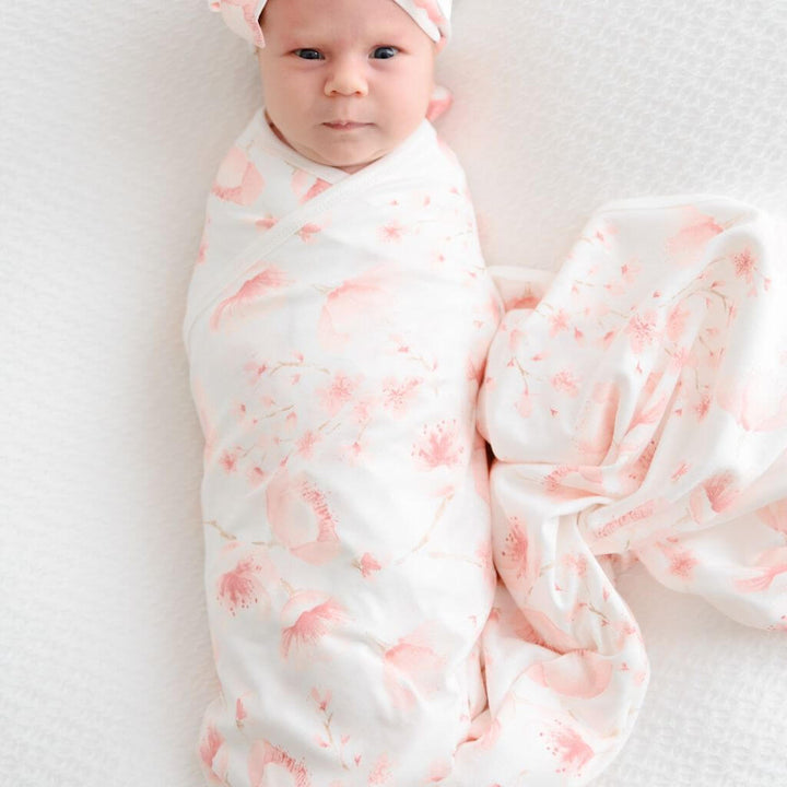 Baby swaddle wrap and beanie in soft jersey cotton with a Cherry Blossom design – gentle comfort for your newborn.