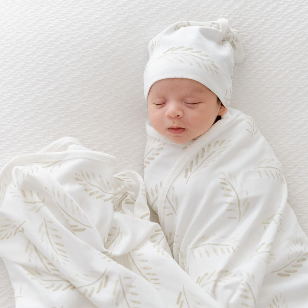 Baby swaddle wrap and beanie in Gold Fern print – lightweight jersey cotton for cosy, breathable comfort.