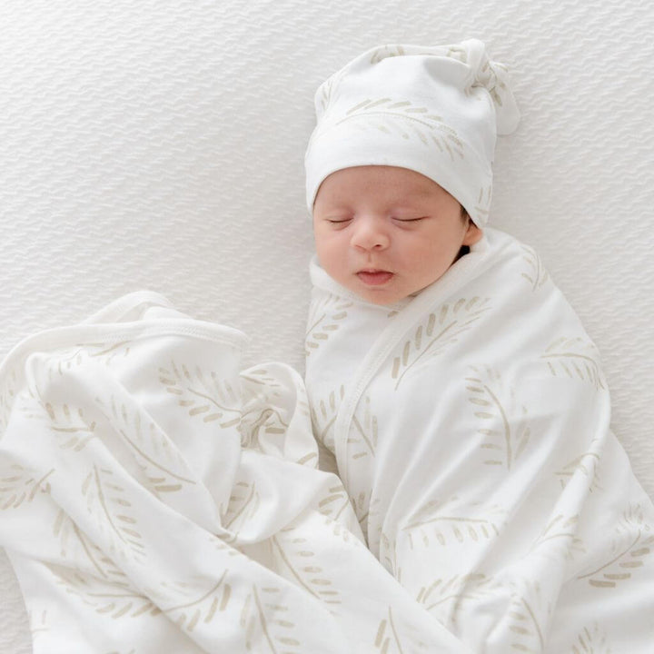 Baby swaddle wrap and beanie in Gold Fern print – lightweight jersey cotton for cosy, breathable comfort.