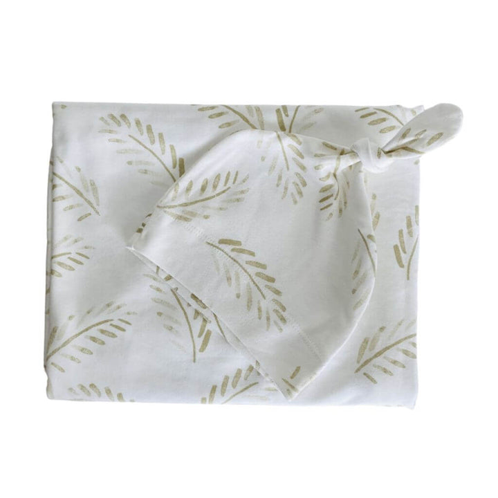 Gold Fern baby swaddle wrap and beanie set in soft cotton – the perfect neutral-toned newborn gift.