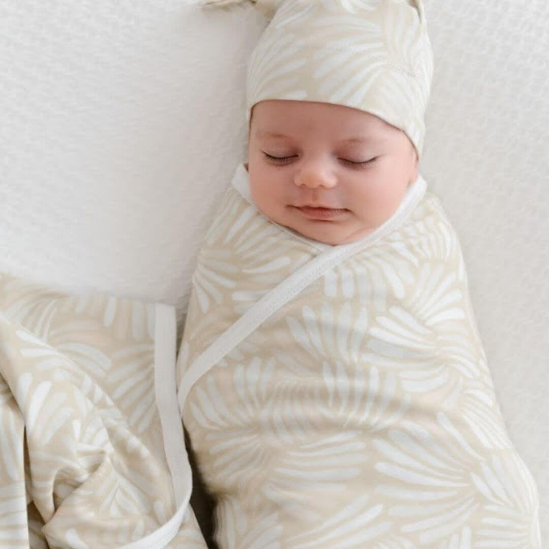Baby swaddle wrap and beanie set in coastal Sandy Shell design by Anchor and Arrow – soft, comfy, and breathable.