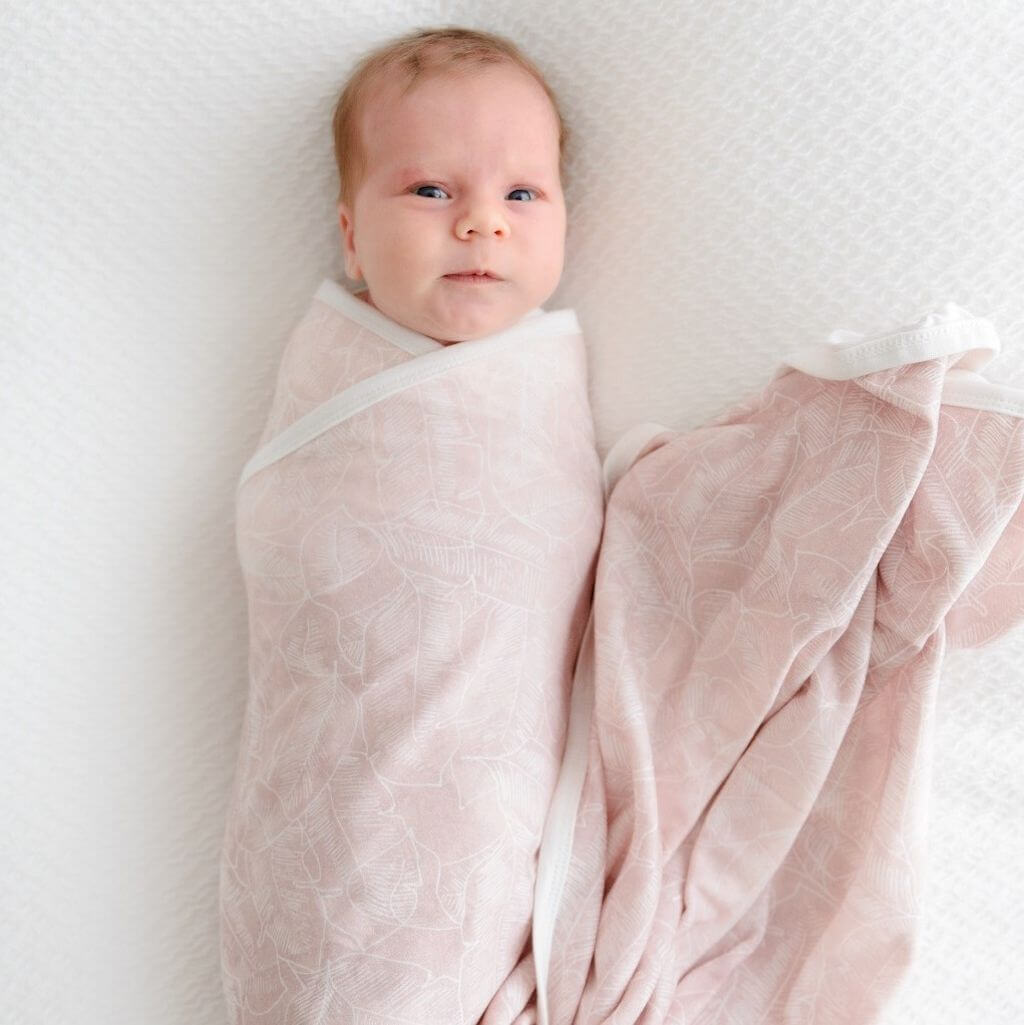 Jersey cotton baby swaddle wrap and beanie in Palm Pink – a stylish and soft baby gift set.