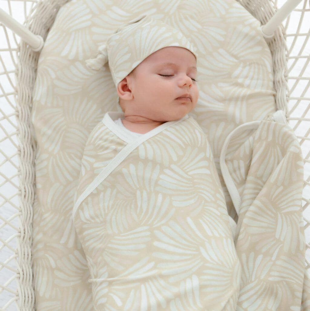 Pink Sandy Shell baby swaddle wrap and beanie – lightweight and cosy for baby naps or gifting.