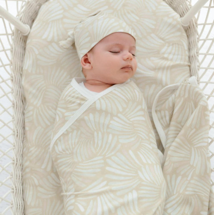 Pink Sandy Shell baby swaddle wrap and beanie – lightweight and cosy for baby naps or gifting.