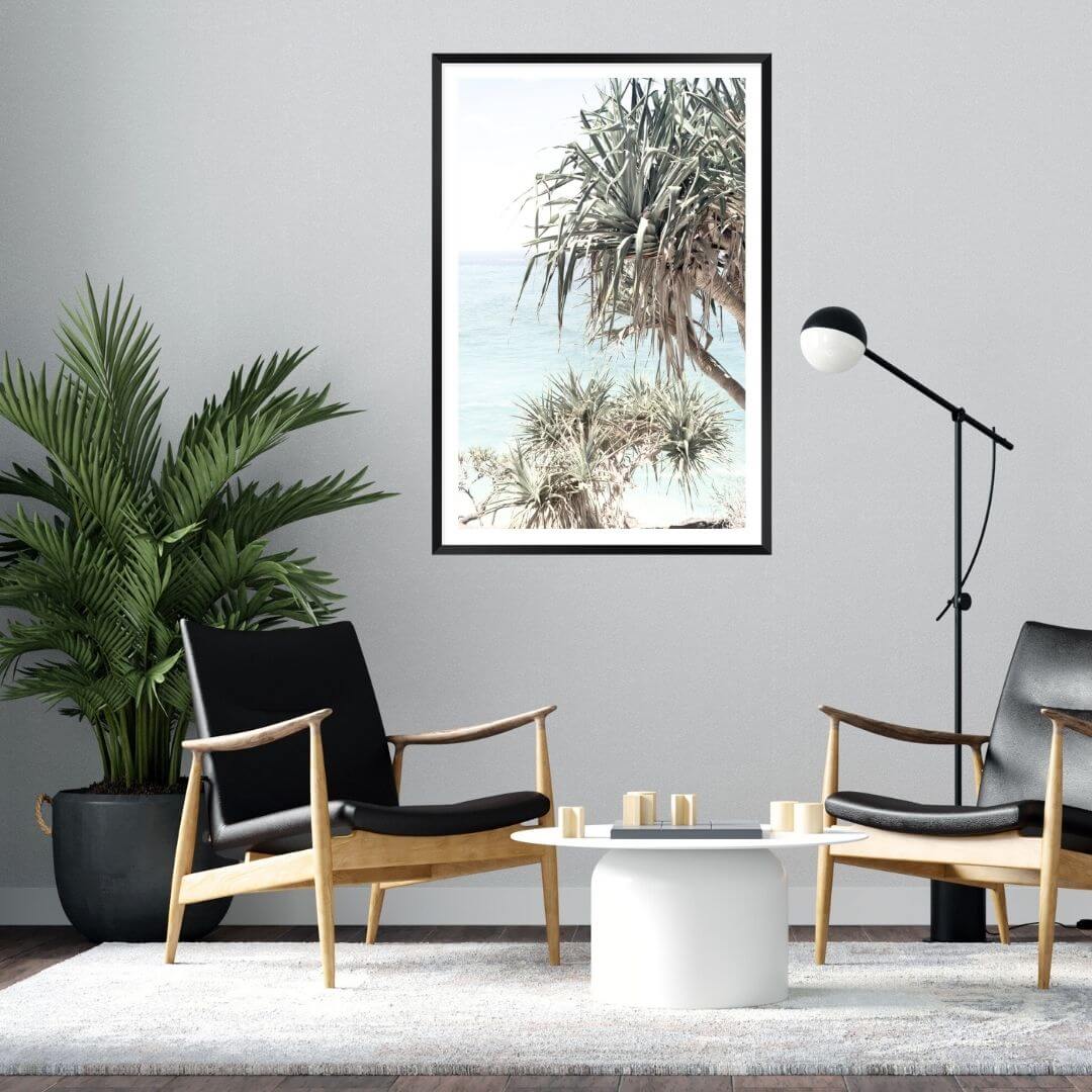 A wall art photo print of the Byron Bay Beach Sea View with a black frame on a wall above a sofa by Beautiful HomeDecor