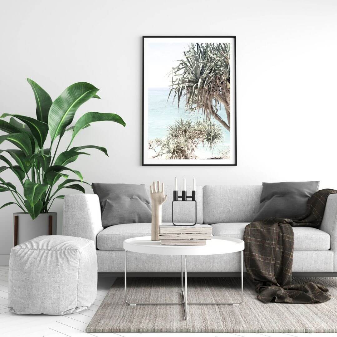A coastal wall art photo print of the Byron Bay Beach Sea View with Pandanus Palms with a black frame or unframed for your coastal living room behind sofa