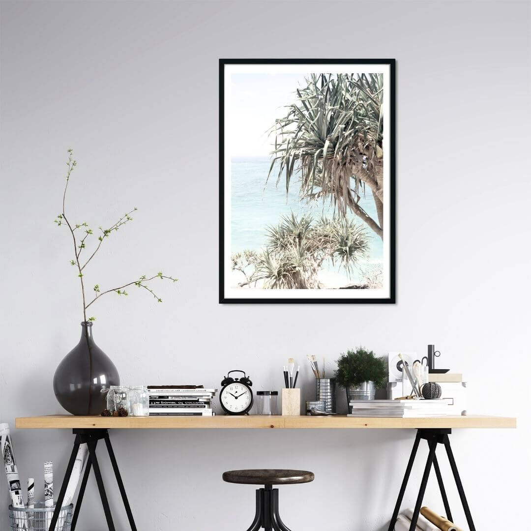 A coastal wall art photo print of the Byron Bay Beach Sea View with Pandanus Palms with a black frame or unframed to decorate a wall in your office