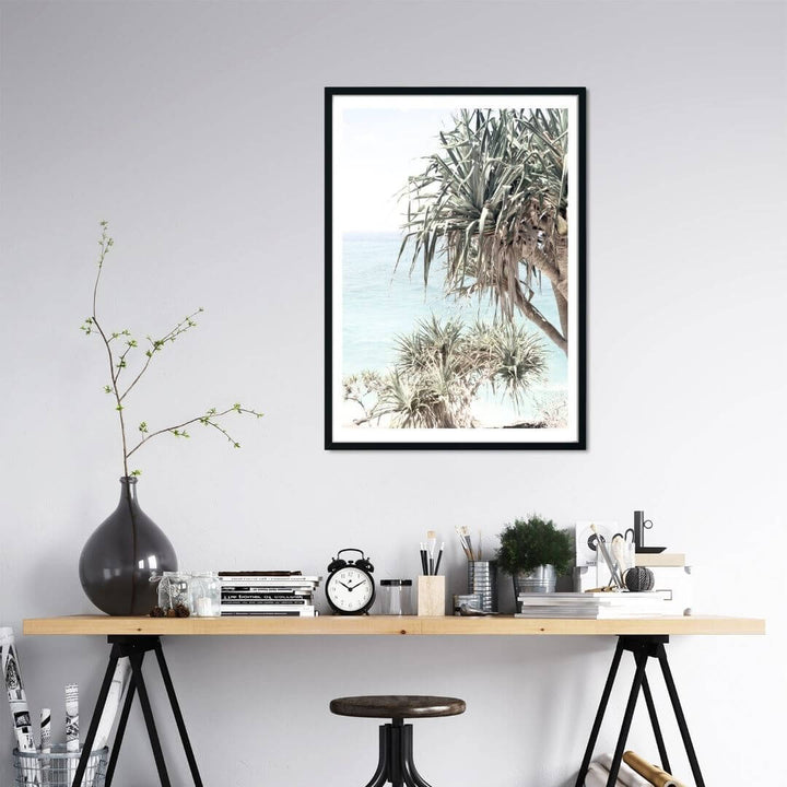 A coastal wall art photo print of the Byron Bay Beach Sea View with Pandanus Palms with a black frame or unframed to decorate a wall in your office