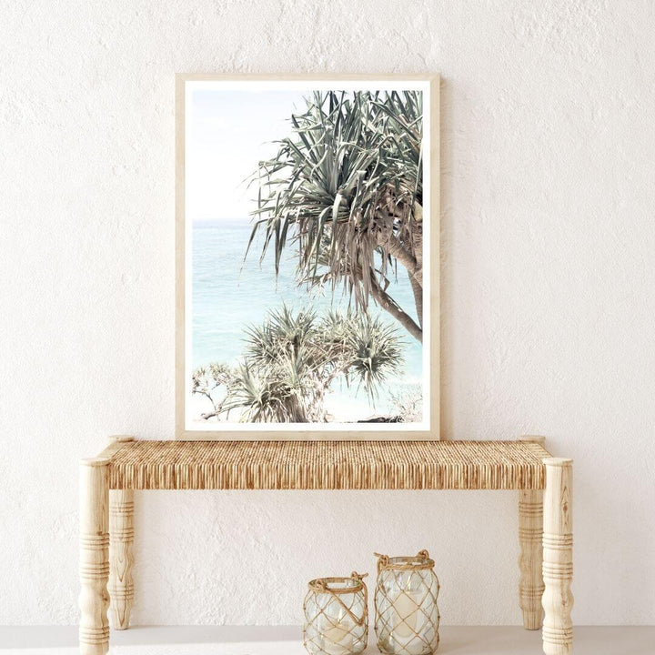 A coastal wall art photo print of the Byron Bay Beach Sea View with Pandanus Palms with a timber frame for the hallway wall with free shipping