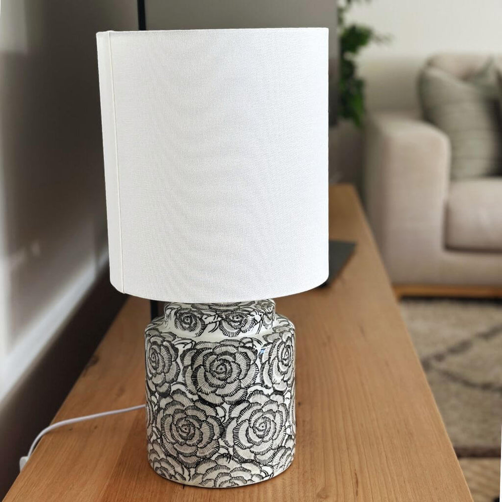 46cm Camellia Hamptons table lamp with white shade and black floral base on a console table