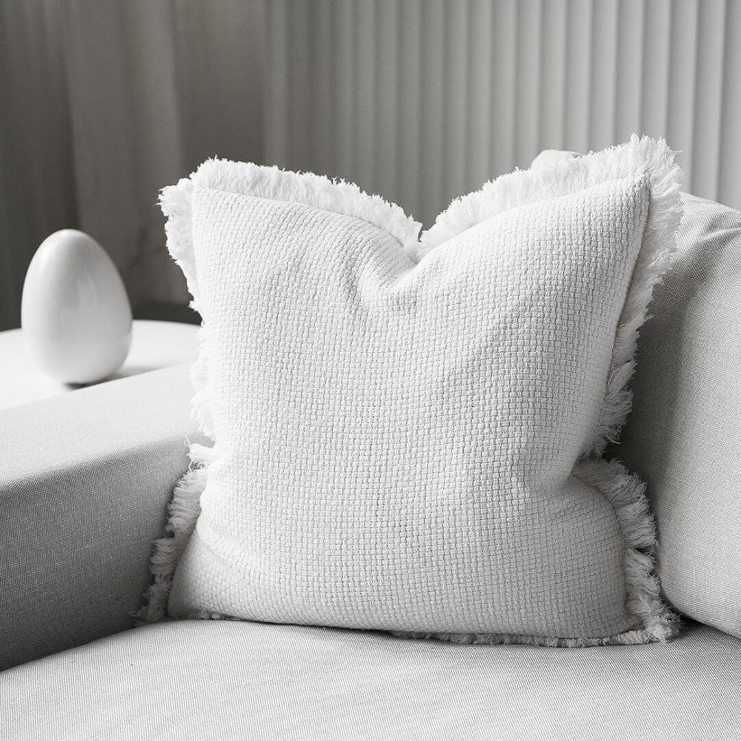 A gorgeous off white Square 60cm Chelsea Fringe Cotton Cushion to add relaxed coastal vibes to your home décor.