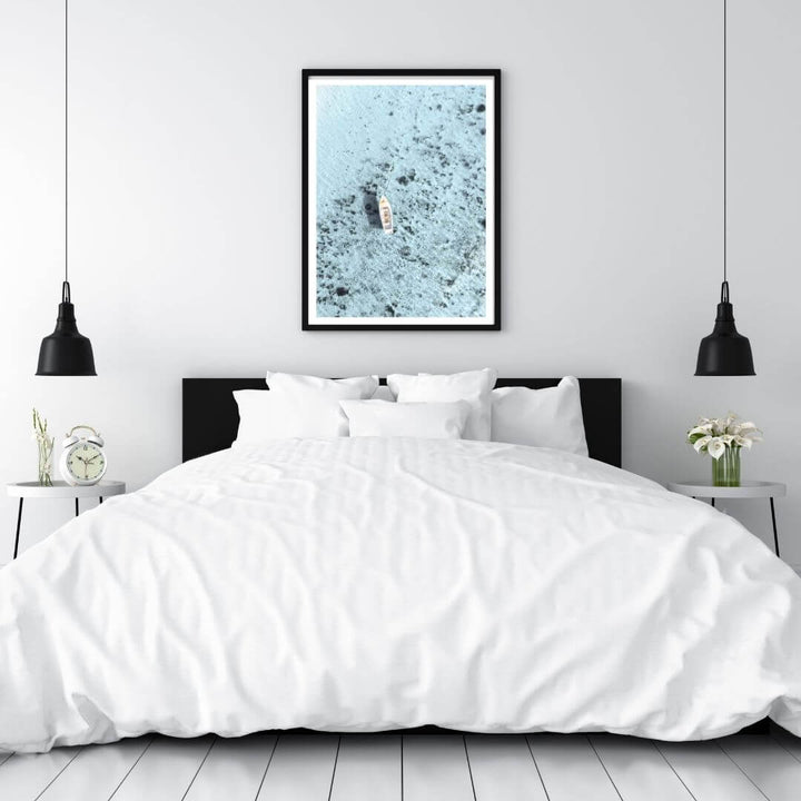 A wall art photo print of a white boat on a clear blue ocean off the Amalfi Coast Italy with a black frame for the wall in your bedroom
