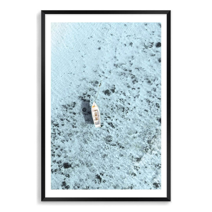 A wall art photo print of a white boat on a clear blue ocean off the Amalfi Coast Italy with a black frame, white border by Beautiful Home Decor