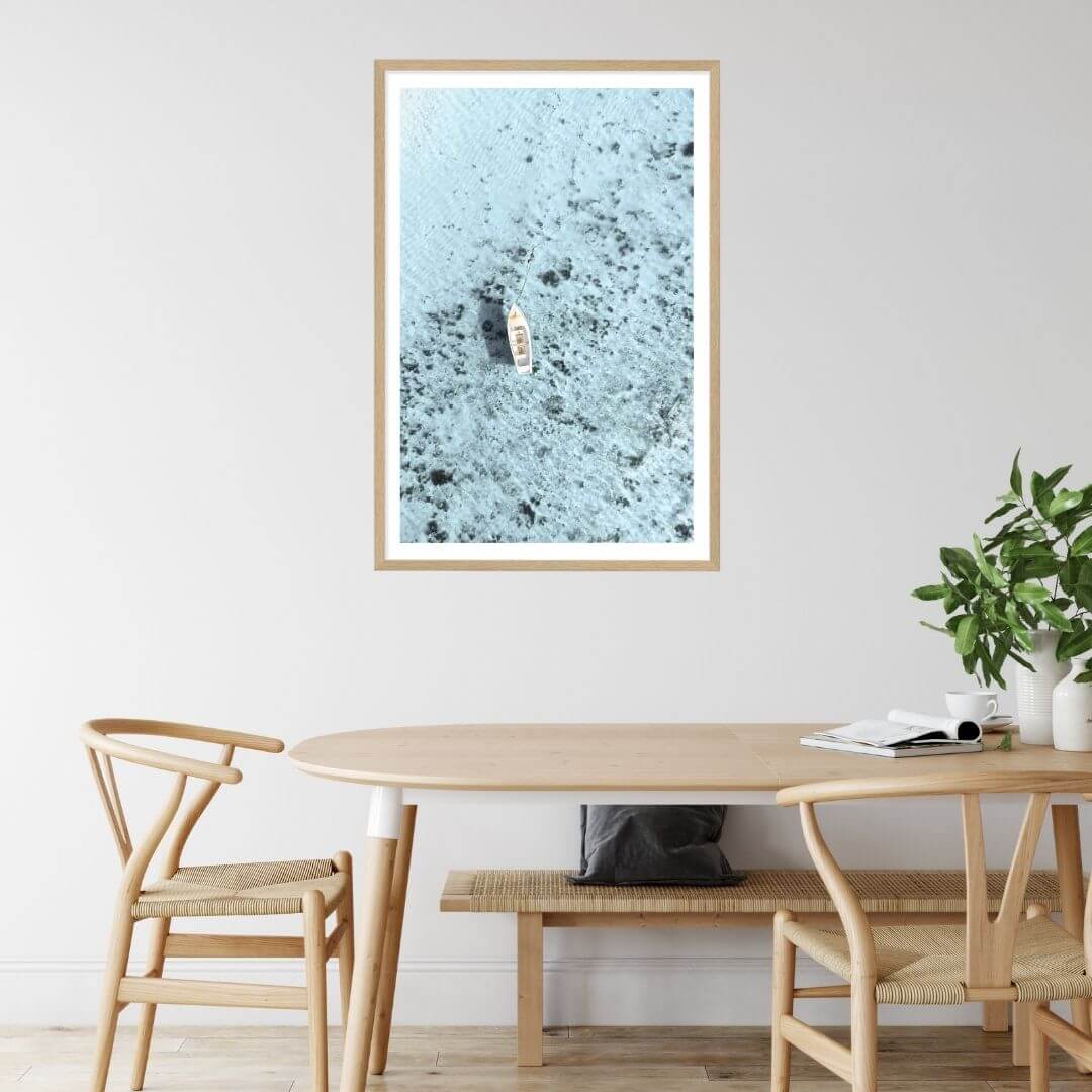 A wall art photo print of a white boat on a clear blue ocean off the Amalfi Coast Italy with a timber frame or unframed to style your dining room walls