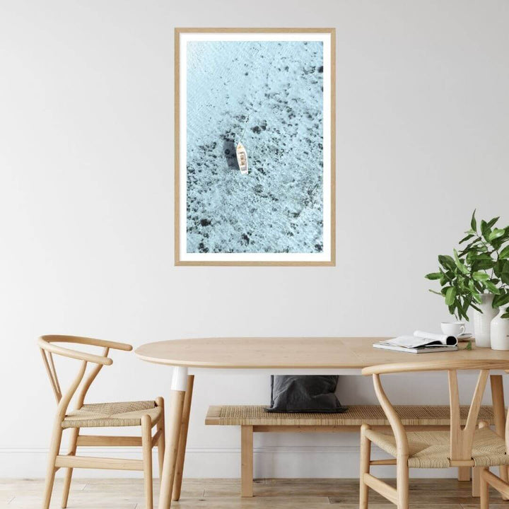 A wall art photo print of a white boat on a clear blue ocean off the Amalfi Coast Italy with a timber frame or unframed to style your dining room walls