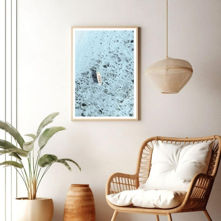 A coastal wall art photo print of a white boat on a clear blue ocean off the Amalfi Coast Italy with a timber frame or unframed to decorate walls in living room