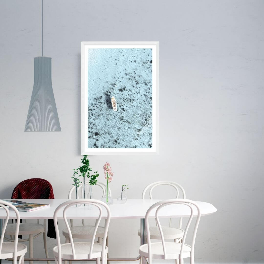 A wall art photo print of a white boat on a clear blue ocean off the Amalfi Coast Italy with a white frame to style an Australian dining room