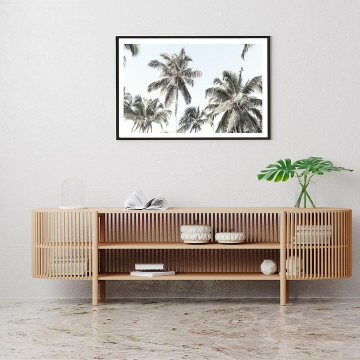 A wall art photo print of coastal palm trees and blue sky with a black frame in hallway shop online at Beautiful Home Decor with free shipping