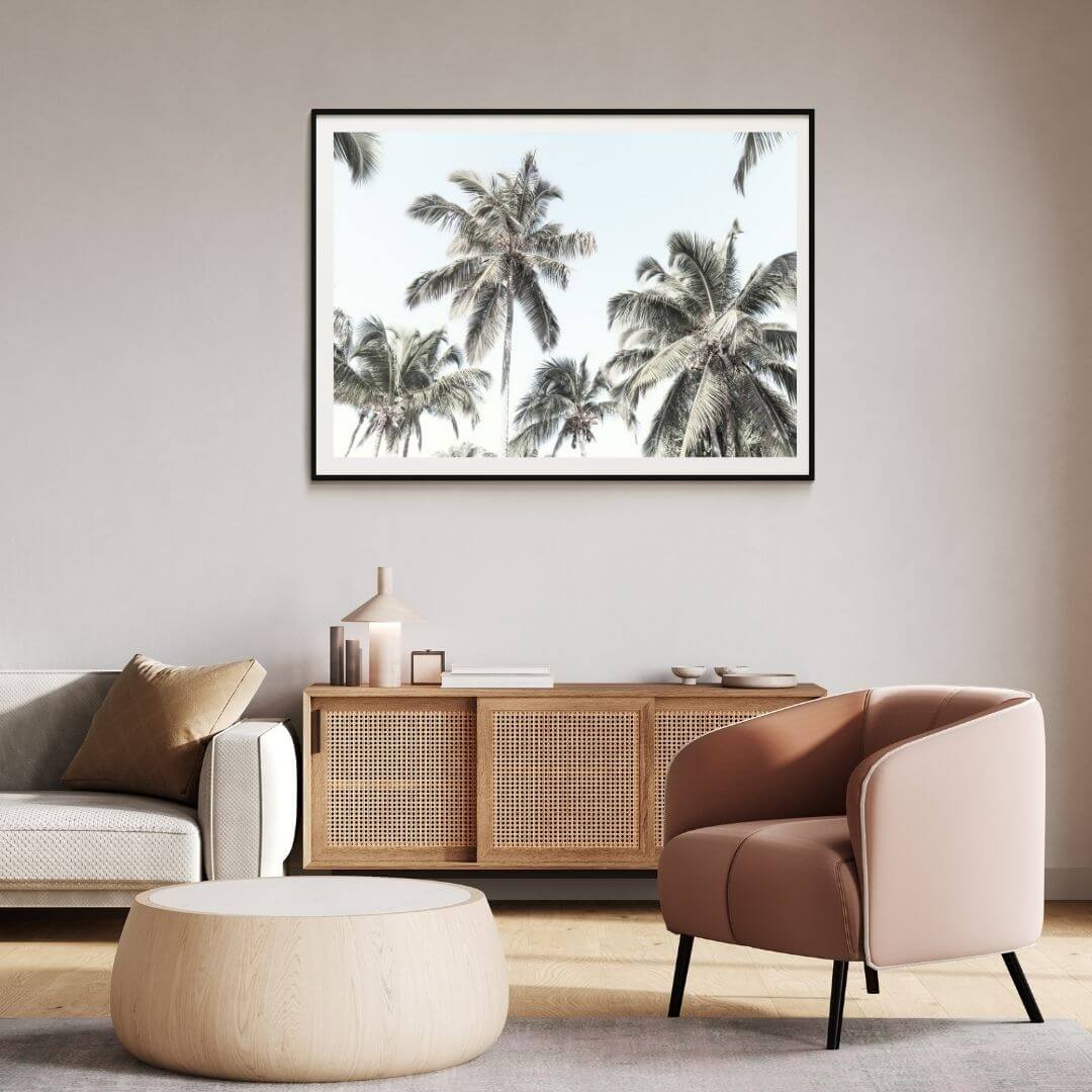 A wall art photo print of coastal palm trees and blue sky with a black frame or unframed for your office study wall