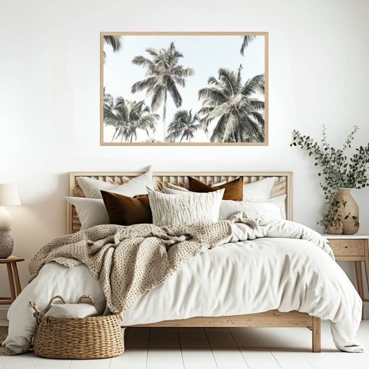 A wall art photo print of coastal palm trees and blue sky with a timber frame to decorate your bedroom by Beautiful Home Decor