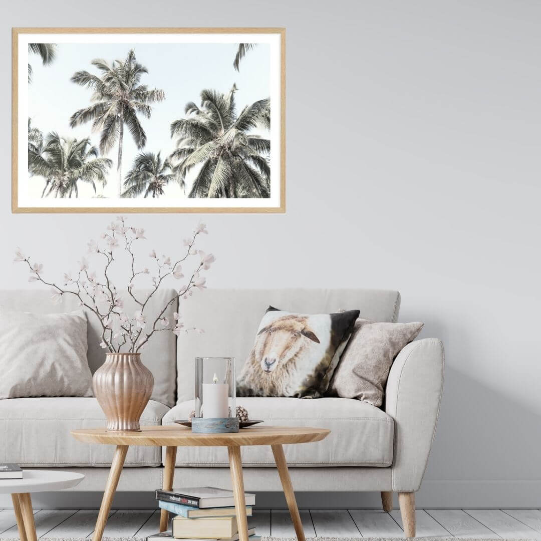 A wall art photo print of coastal palm trees and blue sky with a timber frame or unframed to decorate walls in living room