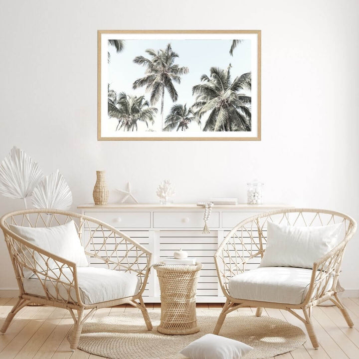 A wall art photo print of coastal palm trees and blue sky with a timber frame for the living room by Beautiful Home Decor