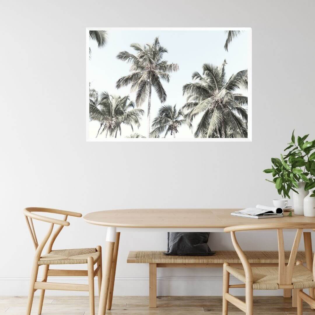 A wall art photo print of coastal palm trees and blue sky with a white frame or unframed to style your dining room walls
