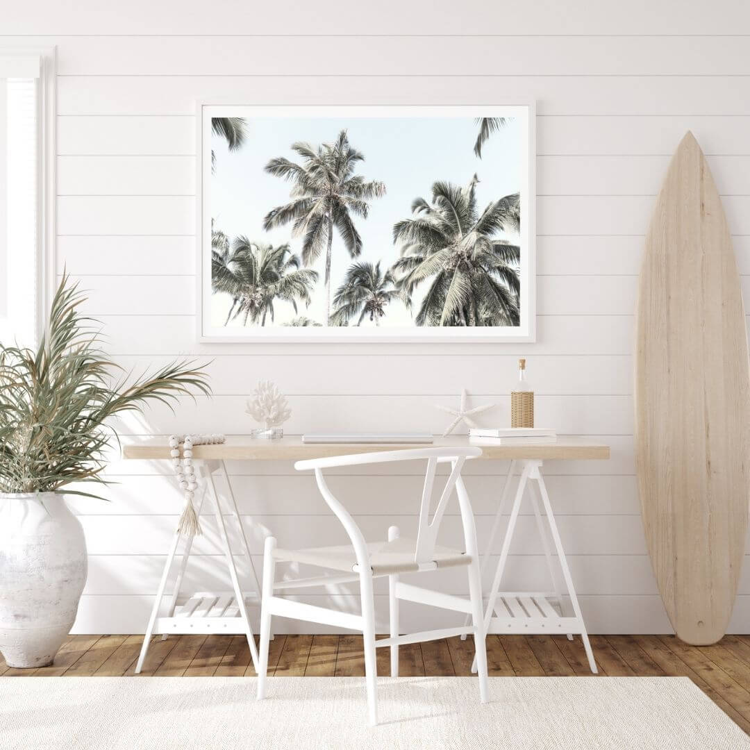 A wall art photo print of coastal palm trees and blue sky with a white frame or unframed for the wall in a kids or teens coastal room