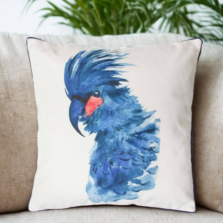 Coastal style square cushion featuring bright blue cockatoo design and feather print back