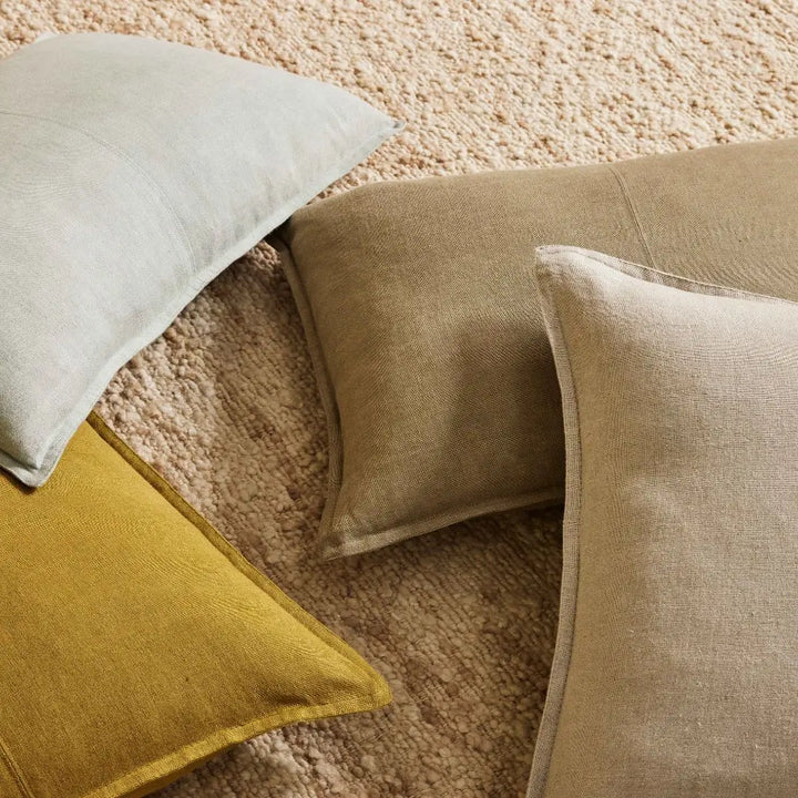3 Como Rectangle linen cushions and 1 square linen cushion on a rug