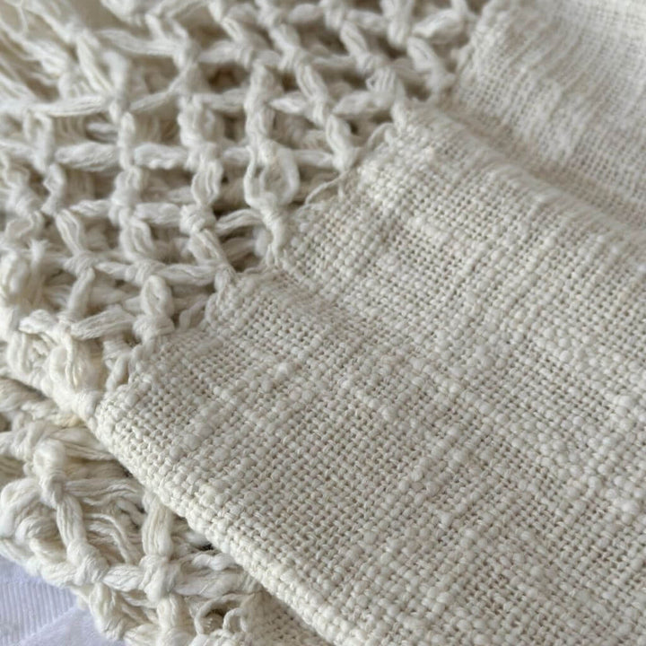 With her beautiful macrame criss-cross pattern tassel edges , the Dove Cotton Throw in Ivory White measures 130cm x 170cm, perfect to decorate and style our bed or sofa