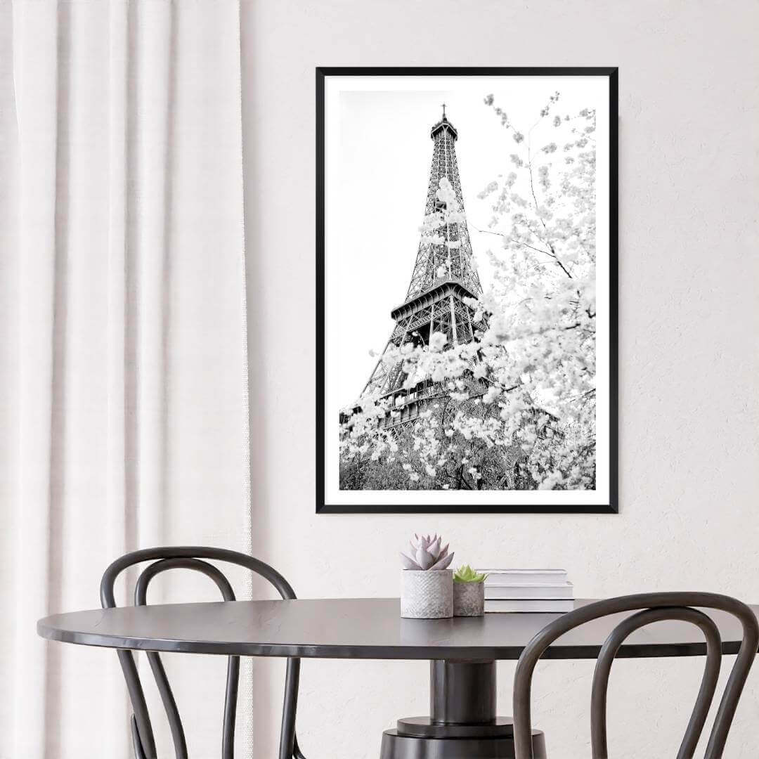 A black and white wall art photo print of the Eiffel Tower in Spring with a black frame to decorate your dining room walls
