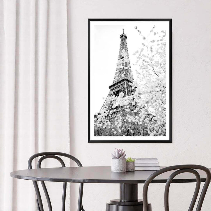 A black and white wall art photo print of the Eiffel Tower in Spring with a black frame to decorate your dining room walls