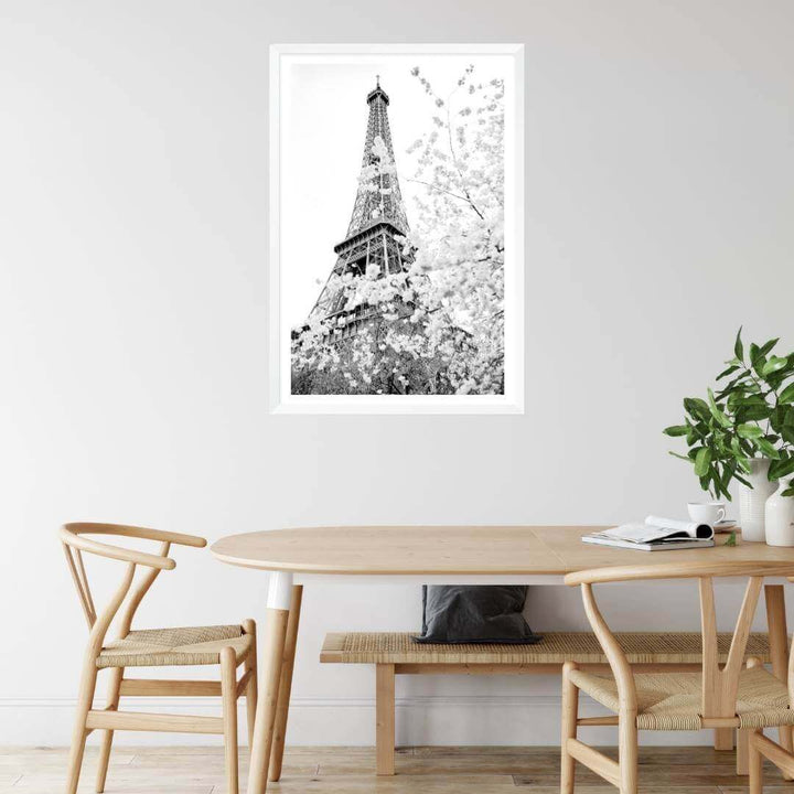 A black and white wall art photo print of the Eiffel Tower in Spring with a white frame or unframed to decorate a wall next to your dining table