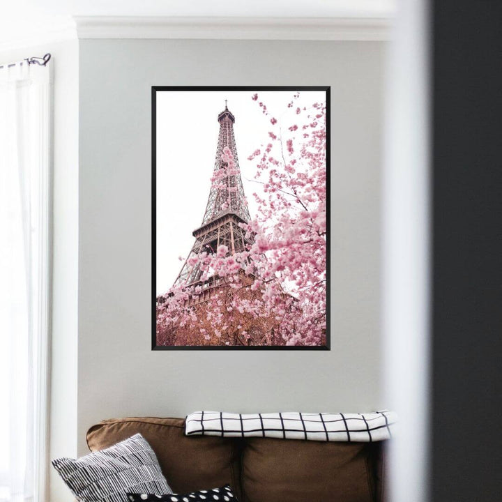 A wall art photo print of the Eiffel Tower in Spring with a black frame on a wall above a sofa by Beautiful HomeDecor
